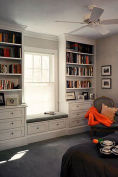 a bed room with a neatly made bed next to a book shelf filled with books