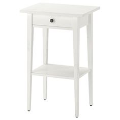 a white nightstand table with one drawer and two shelves on the bottom, against a white background