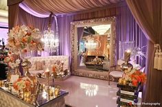 an elaborately decorated living room with chandelier and mirror