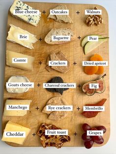 a wooden cutting board topped with different types of cheeses and crackers on top of it