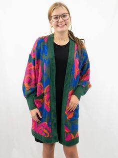 floral multicolor cardigan on model Casual Oversized Green Cardigan, Colorful One Size Cardigan For Fall, Colorful One Size Fall Cardigan, Bohemian Floral Print Winter Cardigan, Casual Floral Print Cardigan For Fall, Casual Multicolor Floral Print Sweater, Trendy Green Cardigan With Pockets, Trendy Oversized Green Cardigan, Bohemian Oversized Cardigan With Pockets