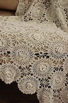 an old lace doily is laying on the floor