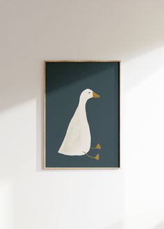 a white duck with yellow feet on a blue background in a wooden frame hanging on the wall