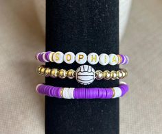 This GameDay volleyball bracelet will score an accessory ace! *Choose a single, double stack, or triple stack bracelet to personalize and support your winning team! *Made with the strongest and best materials, including 6mm heishi beads and 6mm silver or light gold hematite beads. *Please include the following in your personalization: 1) your team name, athlete name(s), mascot, or slogan for the wording 2) your team colors for the heishi beads (see photos for options) 3) your choice of silver or Softball Clay Bead Bracelet, Gameday Sports, Sports Volleyball, Bracelet Business, Team Bracelets, Clay Bracelets, Mom Bracelet, Christian Bracelets, Stack Bracelet