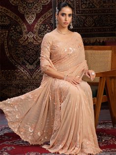 This attractive peach sequins georgette festival wear saree with blouse is the perfect choice for weddings, festivals, parties, and other special occasions.
The vibrant peach color will make you stand out in the crowd, while the intricate sequin work, thread embroidery, and zari work add a touch of elegance and glamour to the saree.
The saree comes in a 5.50-meter length, along with unstitched blouse material, giving you the flexibility to customize it as per your preference. The georgette fabri Peach Georgette Traditional Wear With Pallu, Peach Saree With Resham Embroidery For Reception, Peach Semi-stitched Saree For Wedding, Peach Semi-stitched Saree For Navratri, Bollywood Style Peach Saree For Reception, Bollywood Style Peach Saree For Wedding, Bollywood Peach Saree For Wedding, Festive Peach Pre-draped Saree With Unstitched Blouse, Festive Peach Blouse Piece For Wedding