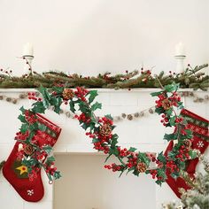 christmas stockings hanging from a mantel decorated with holly and pine cones