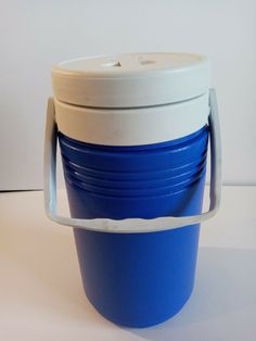 a blue and white plastic cup sitting on top of a table