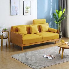 a living room filled with furniture and a wooden table in front of a blue wall