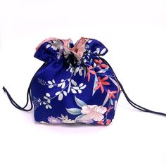 This pouch is made with upcycled vintage kimono fabric on the outside and new cotton fabric on the inside. A Kimono often has unique pattern running down its length, so most of my pouches are one-of-a-kind. Med-weight silky smooth blue silk with floral pattern in white, pink, purple and light blue. Cotton lining is dusty pink with cherry blossom print. It is reversible. Dark Blue Japanese "Edo-uchi" rayon drawcords. *Colors on the monitor/device may be slightly different from actual item. The si Blue Pouch As Gift Bag, Blue Pouch For Gift, Vintage Kimono Fabric, Cherry Blossom Print, Blossom Print, Kimono Fabric, Vintage Kimono, Blue Silk, Upcycled Vintage