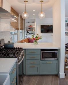 a kitchen with an oven, stove and microwave in it's center island area