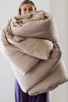 a woman is wrapped in an oversized blanket