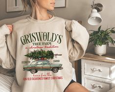 a woman wearing a sweatshirt with an old car and christmas tree on it