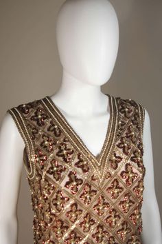 For Sale on 1stDibs - This Galanos blouse is composed of a beaded and sequin appliqued silk, in gold and burgundy hues. The top features a 3-dimensional beading technique. There Luxury Embellished Formal Top, Luxury Embellished Tops For Formal Occasions, Hand Embellished Tops For Festive Party Wear, Hand Embellished Party Tops For Festive Occasions, Festive Hand Embellished Party Wear Tops, Festive Hand Embellished Party Tops, Fitted Hand Embellished Tops For Festive Occasions, Festive Fitted Hand Embellished Tops, Glamorous Hand Embellished Tops For Party