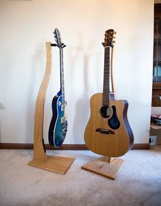 Show off your instrument in style with this gorgeous hardwood guitar stand!  Ditch the cheap metal stand and display your guitar with pride! It's lightweight but can hold the heaviest guitars, and is suitable for any size. You'll play more and improve quicker when the guitar is left out where you can see it! Features: Handmade product in the USA Oak, Maple, and Walnut Hardwood StringSwing hanger is safe for ALL guitar finishes Original Design adds unique accent piece to any space Perfect gift fo Electric Guitar Stand, Violin Stand, Guitar Mount, Wood Guitar Stand, Guitar Finishes, Wooden Guitar Stand, Guitar Hook, Guitar Holder, Wood Business Card Holder