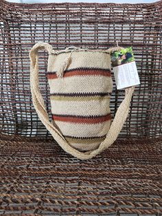 a woven bag sitting on top of a wicker chair next to a magazine holder