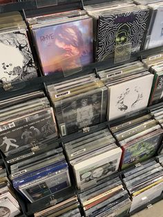 there are many cds on the shelves in this store, all stacked up and ready to be used