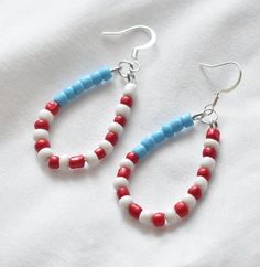 These handmade patriotic American flag beaded earrings are the perfect addition to any outfit. They are lightweight, comfortable, and made of hypoallergenic materials.  2.5 inches in length. You have the option of gold- or silver-colored ear hooks. Care Instructions: - Keep away from moisture - Remove when sleeping - Remove before entering water - Store in cool dry area - Gently wipe with soft cloth to clean These unique handmade earrings would make the perfect birthday gift, anniversary gift, b Red Jewelry With Ear Wire For Independence Day, Red Patriotic Beaded Earrings, Patriotic Beaded Earrings For 4th Of July, Red Beaded Earrings For 4th Of July, Handmade Red Beaded Earrings For 4th Of July, Handmade Patriotic Beaded Earrings, Handmade White Earrings For 4th Of July, Handmade Red Jewelry For Independence Day, Red Handmade Jewelry For Independence Day