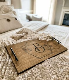 a wooden tray with the number eight on it sitting on top of a bed in a bedroom