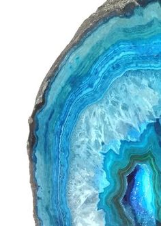 an agate stone with blue and white swirling in it's center, on a white background