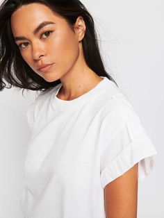 Featuring a contrasting Pima cotton Poplin trim on the extra roomy sleeves and a single button panel on the shoulders, this is an elevated essential for those “jeans and a tee” days. (This one comes in Optic White.) | Nadra Top in Optic White | Ethical Essentials Relaxed Fit Cotton Top With Button Cuffs, Cotton Tops With Button Cuffs And Relaxed Fit, Relaxed Fit Cotton Tops With Button Cuffs, White Cotton Tops With Button Cuffs, Denim Jogger Pants, Basic Shoes, Maxi Jumpsuit, Casual Rompers, Denim Joggers