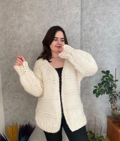 Chunky wool cardigan, oversized cream  jacket, hand knitted cream sweater. This cardigan is knitted by 100% wool. It's great oversized jacket for cold winter days, very soft and warm. If you have any other size preference, please let me know. Happy to accommodate your request. For any other questions, please email me :) The model is 170cm tall.  Length 72cm Width 80cm Sleeve 47cm Hand knit items should be hand washed in warm water with mild detergent and laid flat to dry. Less Winter White Chunky Knit Cardigan, Oversized Hand Knitted Beige Sweater, Cream Chunky Knit Cardigan For Winter, Cozy Knitted Cardigan In Winter White, Cozy Chunky Knit Sweater Coat In Winter White, Cozy Knitted Winter White Cardigan, Oversized Beige Wool Cardigan, Oversized Cream Chunky Knit Sweater Coat, Cream Chunky Knit Sweater Coat