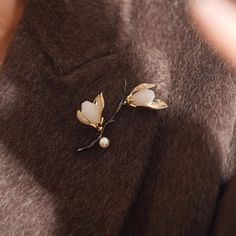 Why We Made This Crafted with meticulous attention to detail, this stunning piece captures the delicate beauty of magnolia blossoms in full bloom. Symbolizing beauty, grace, and resilience, the magnolia flower serves as a timeless emblem of strength and femininity. Wear this brooch as a reminder of your own inner beauty and the power of resilience. Product Details MADE FROM Brass, Zircon, Freshwater Pearl, Serpentine MEASUREMENTS Brooch size : 45 x 60mm / 1.8'' x 2.4'' TURN AROUND 2-3 days CARE Elegant Flower Brooch For Spring, Elegant Spring Brooch Jewelry, Elegant Spring Gift Brooches, Elegant Spring Brooch, Magnolia Blossom, Delicate Beauty, Magnolia Flower, In Full Bloom, Inner Beauty