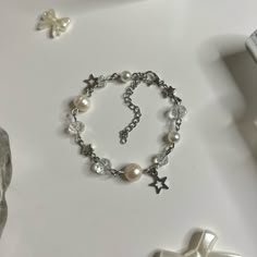 "Pearl Bracelet with Star charms! (adjustable length: with adjuster 5.5\" -> 7.5\") Made with Freshwater pearls, Stainless Steel hardware, and Glass beads Each product is handmade, so slight variations may occur! each is uniquely yours 🤞 🌷͜ (ᵔ ̮ ᵔ)› [ordering 2 or more items from my shop will get you a random freebie]  🍡each order comes with a sticker or candy 🍓CARE INSTRUCTIONS (non ss metals) Keep away from liquids! Creams/Perfumes/Creams, etc. Make sure to remove before showering and slee Bracelet Ideas Metal, Vintage Beaded Bracelets For Gift, Vintage Silver Beaded Bracelets As Gift, Handmade White Beaded Metal Bracelets, Handmade White Beaded Metal Bracelet, Metal Beaded Rosary Bracelet Gift, Metal Beaded Rosary Bracelet For Gift, Bracelet To Make, Pearl Bead Bracelet