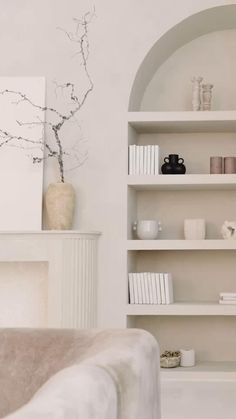 a living room filled with lots of white furniture