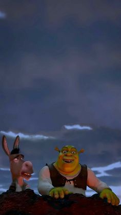 two animated characters sitting on top of a rock