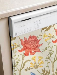 an open dishwasher in a kitchen with flowers on the front and bottom panel