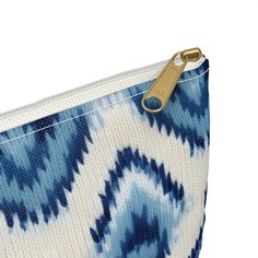 Inspired by the ancient art of Ikat, our blue-hued pouch is a timeless nod to cultural elegance. This trendy accessory brings the charm of Indonesia with its playful Ikat print, adding a touch of coastal chic to your daily adventures. Whether you're on the move or seeking stylish organization, this pouch effortlessly blends casual flair with the richness of ancient Ikat art. Carry the cool blues with you wherever you go!Our pouches vary from small to large and can be used for pretty much anythin Blue Travel Pouch With Zipper Pocket, Everyday Blue Pouch With Zipper Pocket, Blue Pouch With Zipper Closure For Everyday Use, Blue Zipper Pouch For Daily Use, Blue Bags With Zipper Pocket For Personal Use, Blue Cosmetic Pouch Bag For Personal Use, Blue Rectangular Pouch With Zipper Closure, Everyday Blue Pouch With Zipper, Blue Pouch With Zipper Closure As Gift