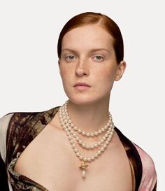 During the late 1980s, Vivienne Westwood debuted her timeless pearl concept in the Harris Tweed Fall 1987 fashion show, showcasing a triple strand choker. The shape of our Three Row Pearl Drop choker recalls the shape of Vivienne's initial creation, displaying a three-dimensional orb motif enhanced with crystal details. Gold Vivienne Westwood, 1987 Fashion, Harris Tweed, Swarovski Pearls, Crystal Embellishment, Pearl Drop, Vivienne Westwood, Necklace Designs, Chain Lengths