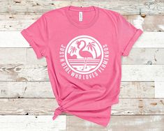 a women's pink shirt that says, i love the world loves flamingos