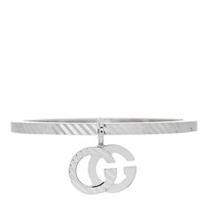 This is an authentic GUCCI 18K White Gold Running G Charm Ring size 53 or 6.5. The ring is crafted of 18K white gold and features a textured band and the running G logo charm. Charm Ring, Gucci Jewelry, G Logo, Charm Rings, The Ring, White Gold Rings, Band Rings, Gold Rings, Ring Size