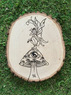 a piece of wood with an image of a mushroom on it and a dragon sitting on top