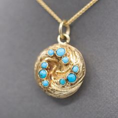 This is an absolutely gorgeous locket that is sure to charm its owner! The locket features a swirl design and is decorated with engraving and nine turquoise beads bezel set into the top. The locket has a glass back which currently holds a plaited lock of hair. If desired that can be removed and a photo or other momento can be placed inside! The locket is crafted in 14k and weighs 3.47g. It measures just shy of 1" in length including the bail, and it is 5/8" across in width. The chain is sold sep Lock Of Hair, Round Locket, Hair Locks, Plaits, Swirl Design, Turquoise Beads, Antique Victorian, Bezel Setting, Locket