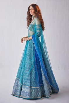 Blue can can attached lehenga with all over printed floral mughal motifs with sequin work. Comes with padded cut-out blouse and ombre dupatta.
Components: 3
Pattern: Printed
Type Of Work: Mughal
Neckline: Off shoulder
Sleeve Type: Three quarter
Fabric: Organza
Color: Blue
Other Details: 
Length: Lehenga: 44 inches
Model Height: 5ft 8inches wearing size XS
Closure: 
Blouse: Back hook
Lehenga: Side closure
Occasion: Sangeet,Cocktail - Aza Fashions Bollywood Style Blue Gown For Festivals, Blue Anarkali Gown With Dupatta, Blue Semi-stitched Gown For Festivals, Semi-stitched Blue Gown For Festivals, Traditional Blue Gown With Pallu, Festive Blue Gown With Dupatta, Blue Anarkali Style Floor-length Lehenga, Blue Gown With Zari Work For Navratri, Blue Gown With Resham Embroidery For Navratri