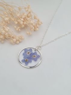 Pretty and dainty forget me not necklace. The necklace is a Y necklace with the pendant hanging on a ring in the middle.  Light and easy to wear and all silver plated. The round pendant measures 20mm in diameter and has three forget me not flowers.  The flowers are preserved in resin. This item ships from the UK within 1 working day. Kyoka Jiro, Dried Flower Jewelry, Flowers Botanical, Botanical Jewelry, Flowers Spring, Birthday Wishlist, Bridesmaid Necklace, Necklace Blue, Mom Gifts