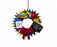 a school bus ornament hanging from a red ribbon on a white background with the words teacher's day written on it