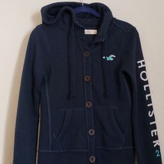 Navy Hollister, Button-Up Hoodie. "Hollister 22" On Left Sleeve. Good Condition, No Rips Or Stains. Long Sleeve Hoodie With Button Closure For Fall, Fall Long Sleeve Hoodie With Button Closure, Fall Cotton Hooded Jacket With Buttons, Casual Hoodie With Buttons For Fall, Casual Fall Hoodie With Buttons, Casual Hooded Jacket With Button Closure, Casual Long Sleeve Hooded Jacket With Button Closure, Hooded Hoodie With Button Closure For Fall, Button Closure Hoodie For Fall