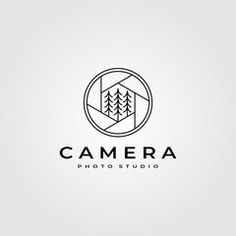 a camera logo with trees in the background