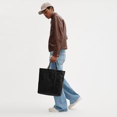 Our Hall is made for doing it all (just like you). Crafted of our pliable lightest weight leather with a soft feel this open top carryall has a durable fabric lining a zip pocket to keep essentials secure and space for a 16 laptop. Finished with our Signature hardware it features both slim shoulder straps and top handles for versatile wear. (Tote it your way.) | Coach Hall Tote Bag - Black Large Sac De Jour Men’s Replica, Men With Tote Bags, Men’s Bags, Coach Bag Men, Tote Bag Men, Office Ootd, Tote Bag Coach, Tote Bag For Men, Mens Tote Bag