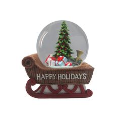 a snow globe sitting on top of a sleigh with a christmas tree in it