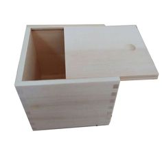 an empty wooden box sitting on top of a white surface