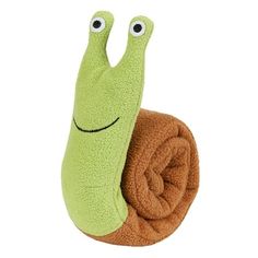 a green slug stuffed animal laying on top of a brown blanket with its eyes closed