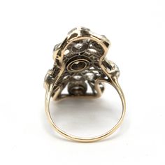 This fantastic Edwardian ring, most likely made in the 1910s, contains 13 Old Mine Cut and European Cut diamonds set in platinum and supported by a yellow gold band. The top is beautifully filigreed in a delicate lace motif typical of the period. Metal: Platinum & 14K Yellow Gold Main Stones: 1 Old Mine Cut Diamond (approx. 0.29 carat, J-K color, SI1-SI2 clarity, 4.3 x 3.8 x 2.8mm), 2 Old European Cut Diamonds (approx. 0.50 carat total, J-K color, SI1-SI2 clarity, 4.0 - 4.1mm) Accent Stones: 10 Antique Yellow Gold Rings With Rose Cut Diamonds, Victorian Yellow Gold Rings With Rose Cut Diamonds, Victorian Yellow Gold Rings With Brilliant Cut, Victorian Yellow Gold Cluster Ring With Diamond Accents, Victorian Cluster Ring With Diamond Accents In Yellow Gold, Antique Cluster Ring With Diamond Accents, Victorian 14k Gold Diamond Ring With Diamond Accents, Antique Platinum Yellow Gold Rings, Victorian 14k Gold Diamond Ring With Accents