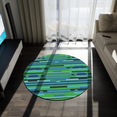 a living room with a couch, television and large window looking out onto the ocean