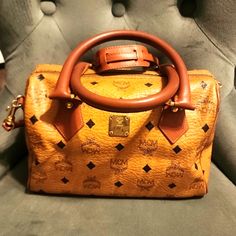 Beautiful Vintage Mcm Boston Bag In Cognac With Signature Mcm Print. Please Review Pictures And Ask Any Questions Prior To Purchase. Pictures Are Part Of The Description. Includes Mcm Strap - Rare, Strap Sells Itself For $200. Some Scratches To Mcm Plate On Front Of Bag. Otherwise, There Are No Major Callouts. This Is A Vintage Luxury Bag. Please Manage Expectations. Corners And Bottom Of Bag In Excellent Condition. Mcm Bags, Luxury Bag, Vintage Color, Boston Bag, Vintage Colors, Cognac, Luxury Bags, Black And Brown, Boston