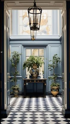 an entry way with potted plants and a chandelier