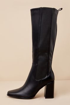 Every look you create with the Thia Black Square Toe Knee-High Boots will be worth everyone's attention! Sleek faux leather shapes these perfectly chic boots that feature a trendy square-toe upper that rises to a 13.5"" knee-high shaft with an elastic gusset along the outstep, a 15.25"" zipper at the instep, and a convenient pull tag at the bag. 14"" circumference. A sturdy block heel completes the stylish design! Available in whole sizes only. 3. 25" wrapped block heel. Lightly cushioned insole Trendy Faux Leather Heeled Boots With Block Heel, Trendy Faux Leather Boots With Block Heel, Trendy Tall Mid-calf Leather Boots, Trendy Wide Calf Faux Leather Knee-high Boots, Trendy Wide Calf Knee-high Boots In Faux Leather, Trendy Wide Calf Faux Leather Boots, Chic Ankle Boots In Polyurethane, Chic Polyurethane Ankle Boots, Trendy Faux Leather Knee-high Boots With Square Toe